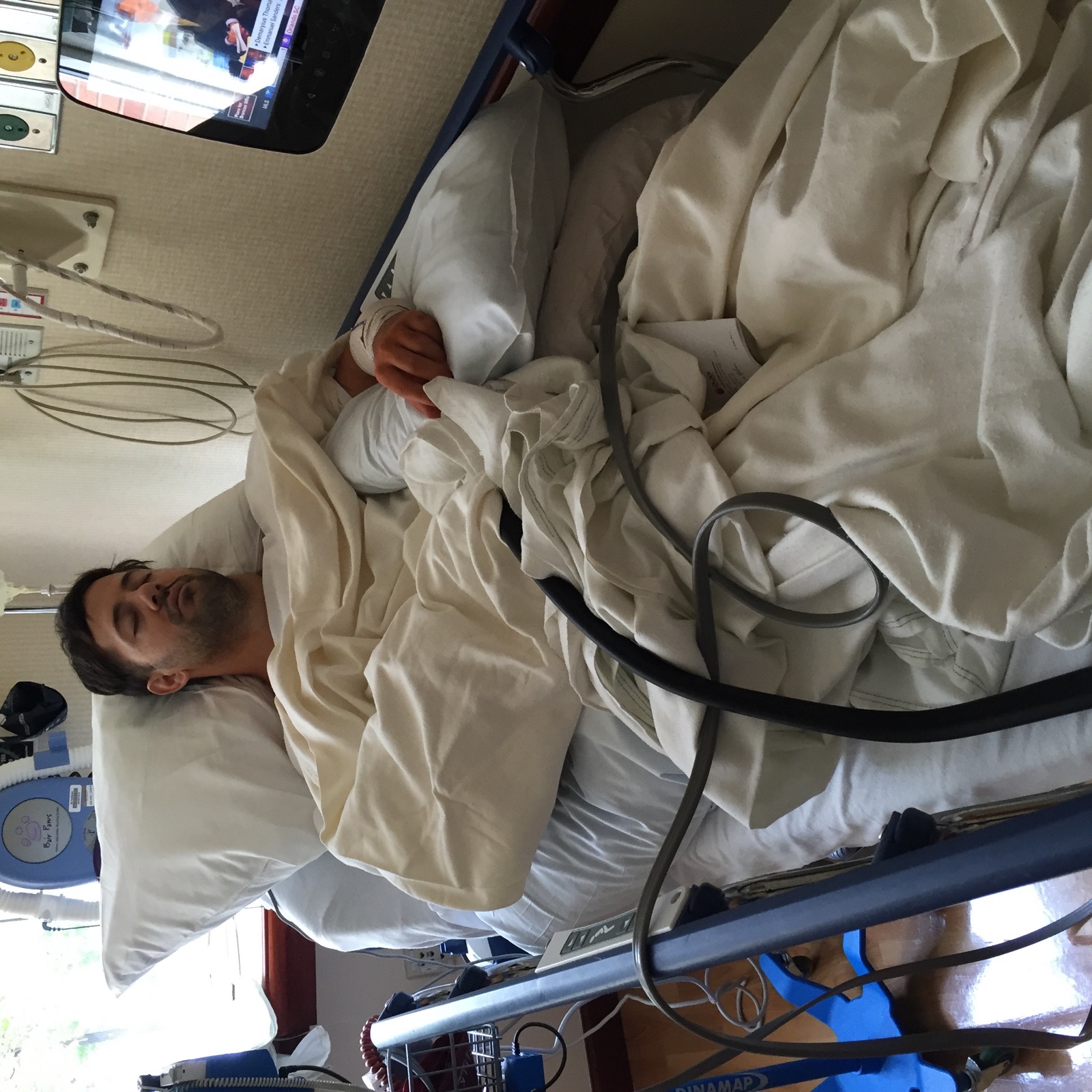 Eric Pellini recovering in a hospital bed after elbow surgery