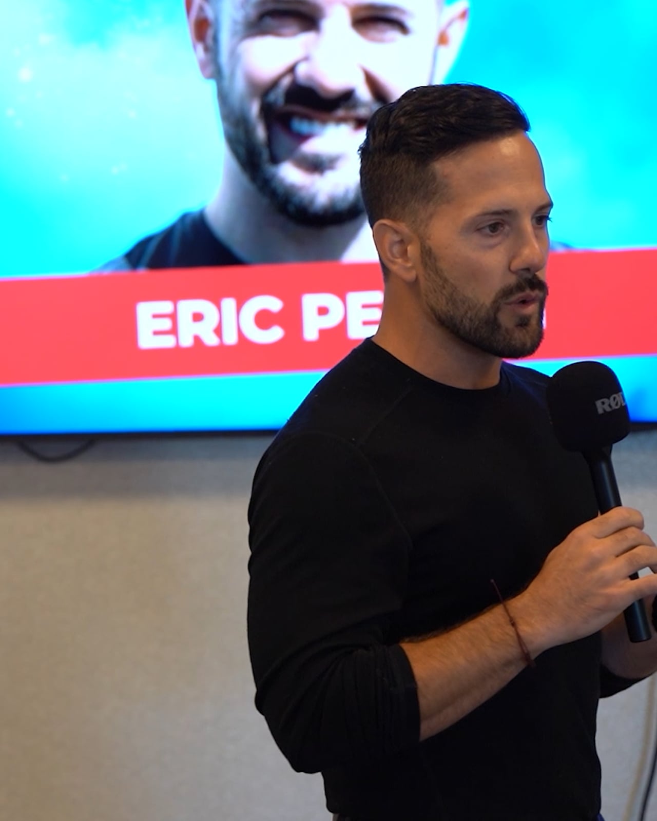 Eric Pellini speaking into a microphone